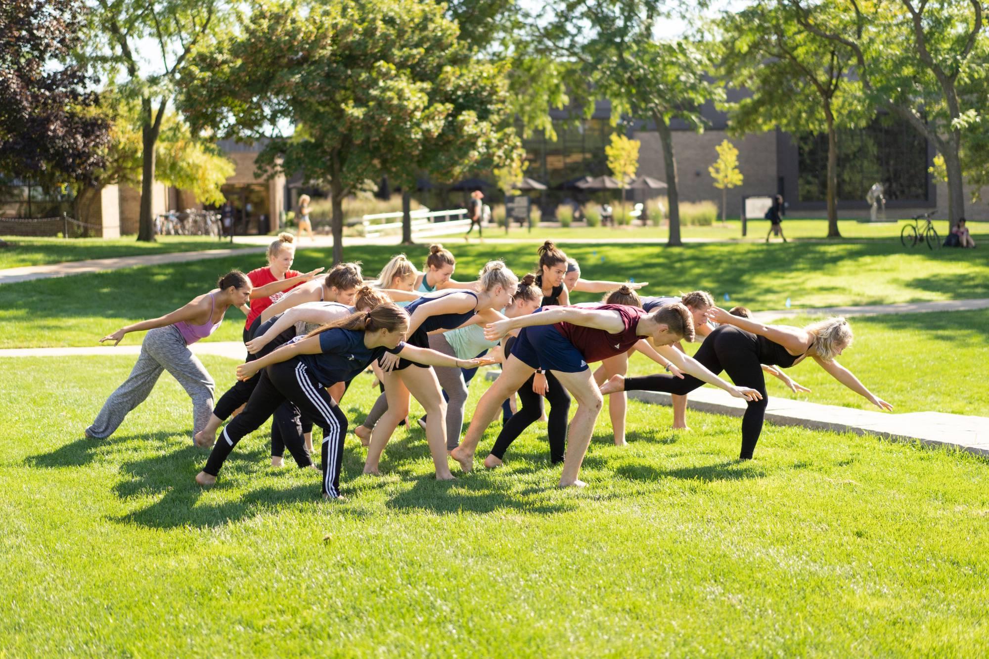 Dance students outdoors performing a group dance together